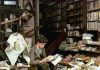 A boy sits and reads among the ruins of a bookshop that was destroyed during an air raid in London, United Kingdom, in 1940.